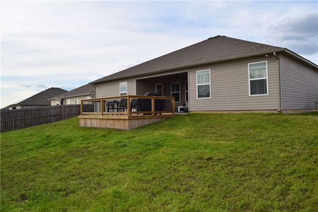 rear view of property with a wooden deck