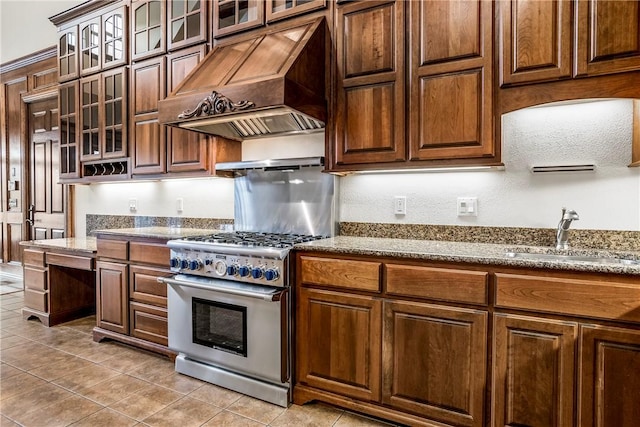 15533 Haynes Rd, Rogers, AR 72756 - kitchen featuring high end stainless steel range, custom range hood, a sink, light tile patterned floors, and stone countertops