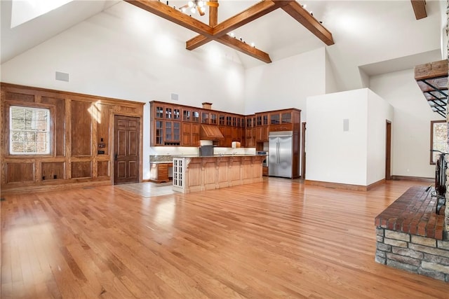 15533 Haynes Rd, Rogers, AR 72756 - unfurnished living room with high vaulted ceiling, light wood-type flooring, and a chandelier