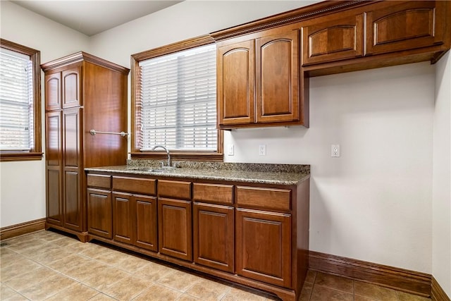 15533 Haynes Rd, Rogers, AR 72756 - kitchen with baseboards, a sink, dark countertops, and light tile patterned flooring