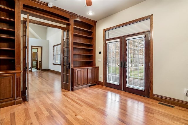 15533 Haynes Rd, Rogers, AR 72756 - spare room with french doors, light wood finished floors, baseboards, and healthy amount of natural light