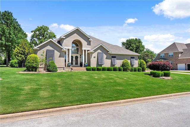 ranch-style home with french doors, a front lawn, and stucco siding