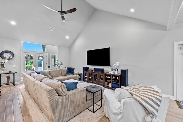 living area featuring high vaulted ceiling, ceiling fan, light wood-style flooring, baseboards, and french doors