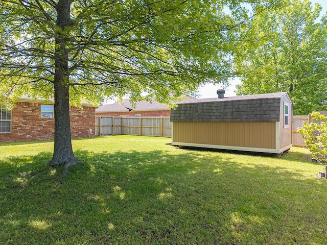 view of yard featuring a storage unit and an outbuilding