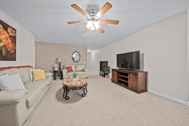 living area featuring carpet flooring, a ceiling fan, baseboards, and vaulted ceiling