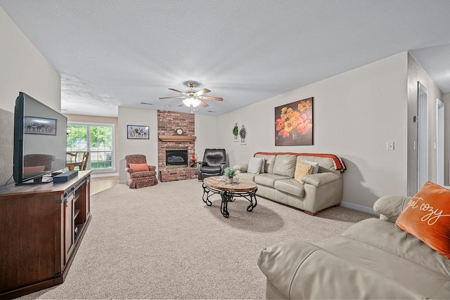 living room featuring carpet floors, ceiling fan, and a fireplace