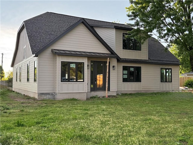 502 Concord St, Lowell, AR 72745 - modern farmhouse featuring a shingled roof, a front lawn, a standing seam roof, and metal roof