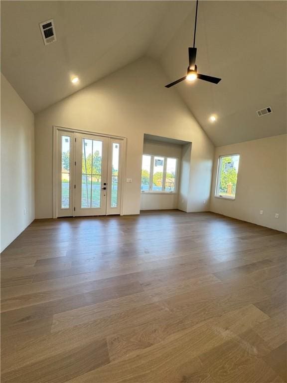 502 Concord St, Lowell, AR 72745 - empty room featuring high vaulted ceiling, plenty of natural light, a ceiling fan, and wood finished floors