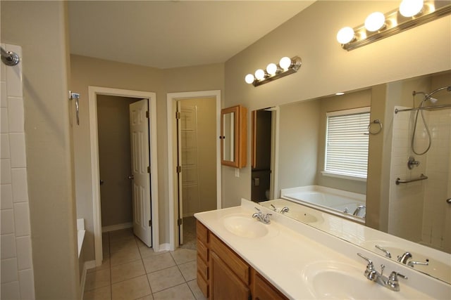 bathroom featuring a bath, tiled shower, tile patterned floors, double vanity, and baseboards