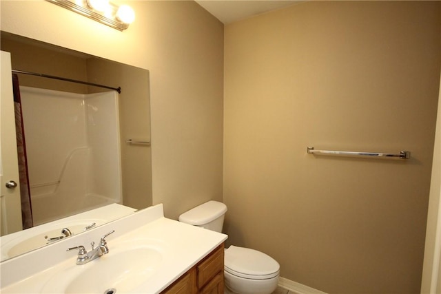 full bathroom with a shower, toilet, vanity, and baseboards