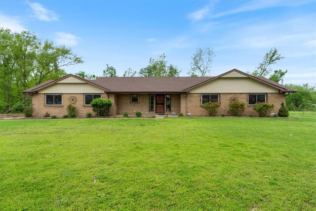 ranch-style house with a front lawn and brick siding