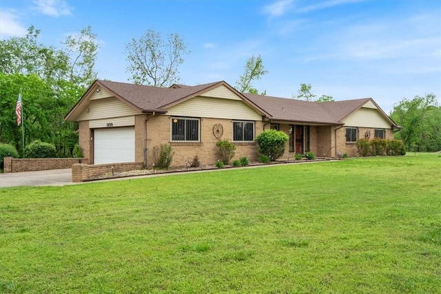 single story home featuring a garage, concrete driveway, brick siding, and a front lawn