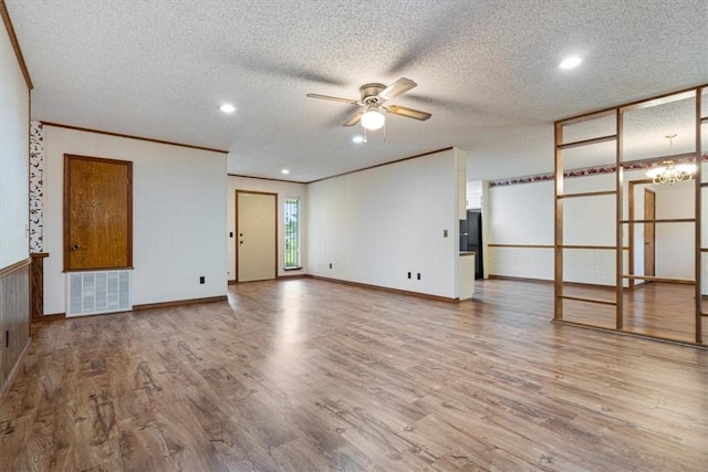 unfurnished living room with wood finished floors, ornamental molding, a ceiling fan, a textured ceiling, and recessed lighting