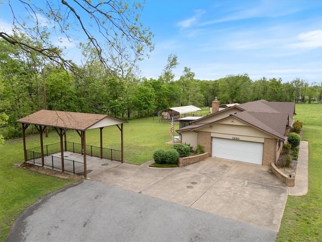 view of home's community with driveway, a garage, and a gazebo