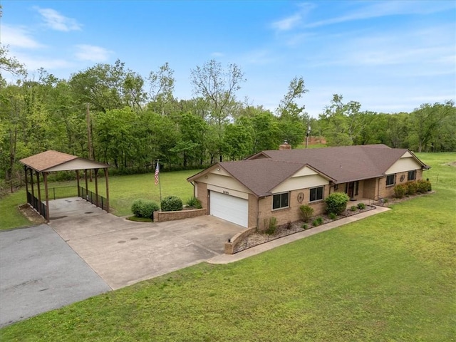 ranch-style house featuring driveway, a front yard, brick siding, a view of trees, and a garage