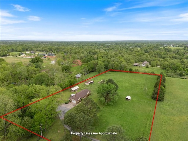aerial view of sparsely populated area with a forest and property parcel outlined