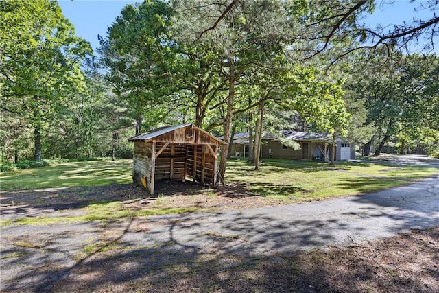 10616 S Liberty Rd, Dardanelle, AR 72834 - view of green lawn with a garage and an outbuilding