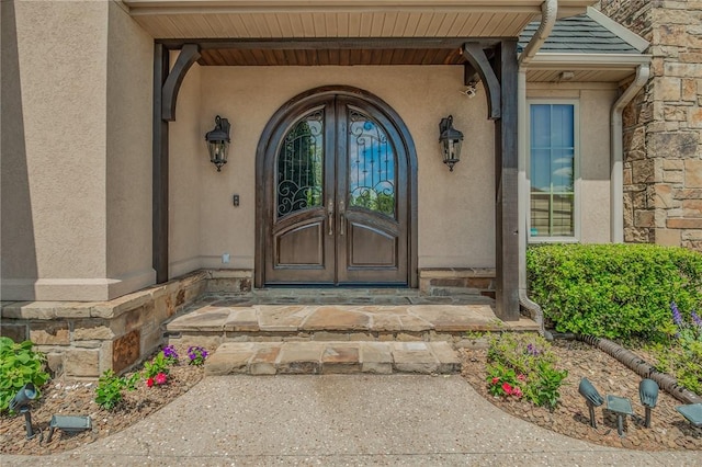 7 W Colonial Dr, Rogers, AR 72758 - entrance to property with stucco siding, french doors, and stone siding