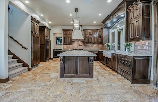 7 W Colonial Dr, Rogers, AR 72758 - kitchen featuring premium range hood, a sink, high end black refrigerator, a center island, and backsplash