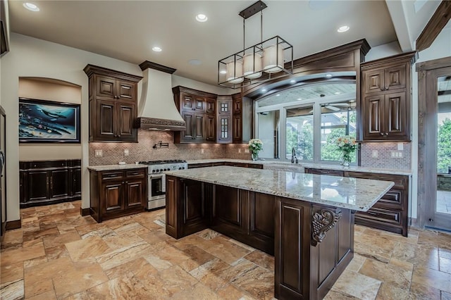 7 W Colonial Dr, Rogers, AR 72758 - kitchen featuring high end stainless steel range, premium range hood, dark brown cabinets, stone tile floors, and recessed lighting