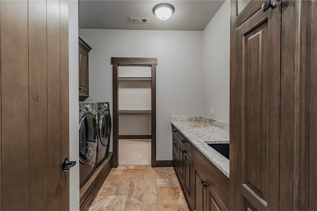 7 W Colonial Dr, Rogers, AR 72758 - clothes washing area featuring cabinet space, washer and clothes dryer, stone tile flooring, and baseboards