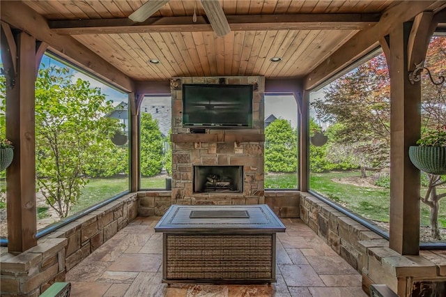 7 W Colonial Dr, Rogers, AR 72758 - sunroom / solarium featuring an outdoor stone fireplace, stone tile flooring, wood ceiling, beam ceiling, and healthy amount of natural light
