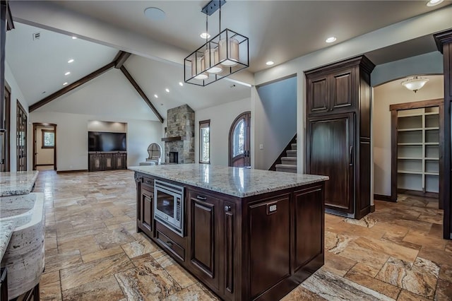 7 W Colonial Dr, Rogers, AR 72758 - kitchen featuring stainless steel microwave, stone tile floors, open floor plan, decorative light fixtures, and recessed lighting