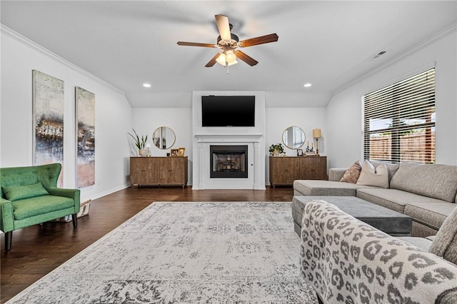 living area featuring crown molding, ceiling fan, dark wood finished floors, recessed lighting, and a fireplace