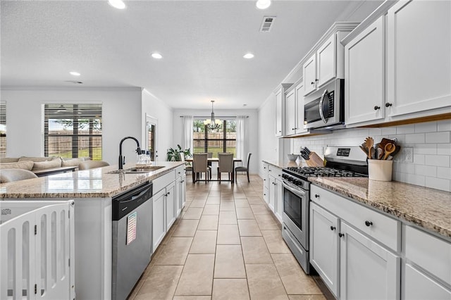 kitchen with stainless steel appliances, a sink, light tile patterned floors, recessed lighting, and tasteful backsplash