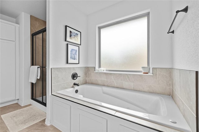 full bath with a shower stall and a bath