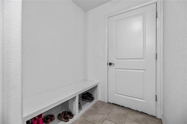 mudroom featuring light tile patterned floors and baseboards