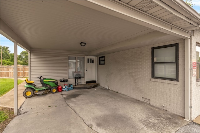 view of patio / terrace featuring an attached carport and fence