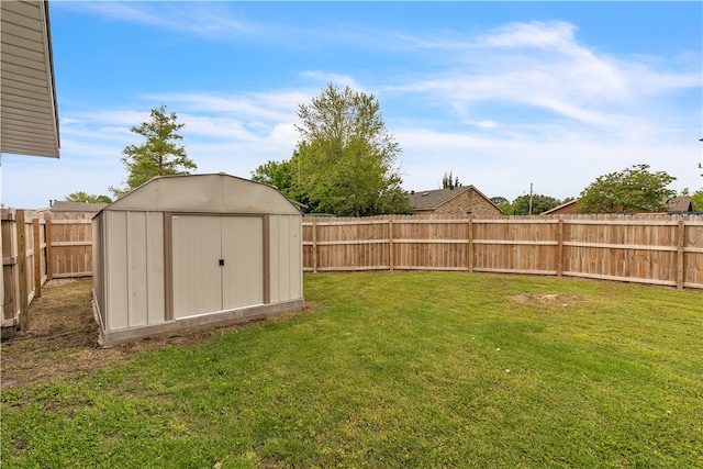 view of yard with a storage shed and an outbuilding