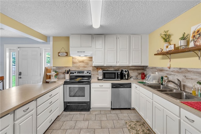kitchen with stainless steel appliances, a sink, under cabinet range hood, open shelves, and backsplash