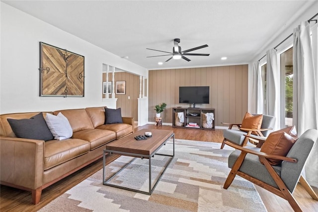 living room featuring a ceiling fan, wood finished floors, baseboards, and recessed lighting