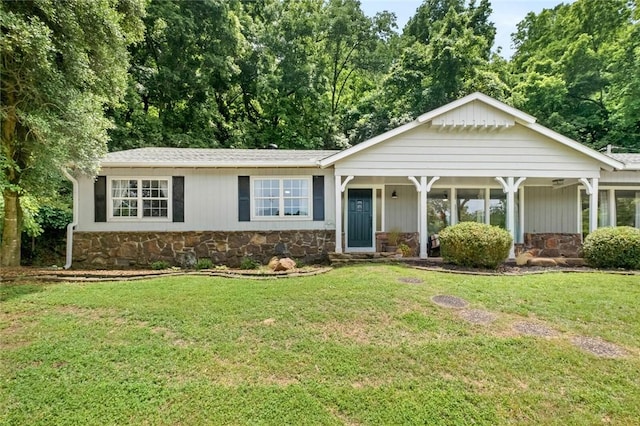 single story home with stone siding and a front yard