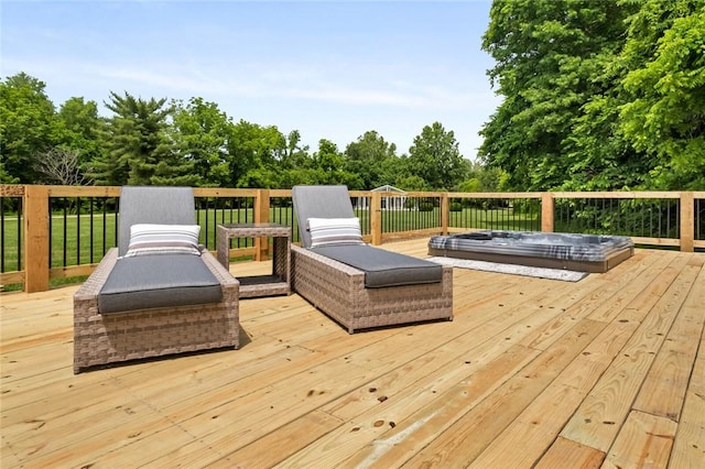 wooden deck featuring view of wooded area