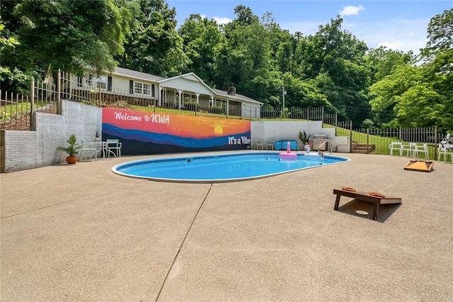 view of pool with a patio and fence