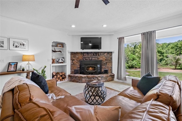 living area with a textured ceiling, ceiling fan, recessed lighting, built in features, and baseboards