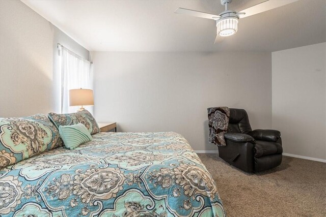 carpeted bedroom featuring baseboards and ceiling fan