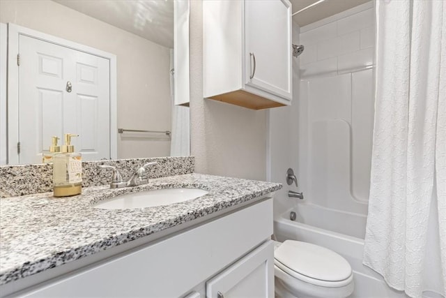 bathroom featuring shower / tub combo with curtain, toilet, and vanity