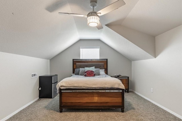 bedroom with carpet, a ceiling fan, lofted ceiling, freestanding refrigerator, and baseboards