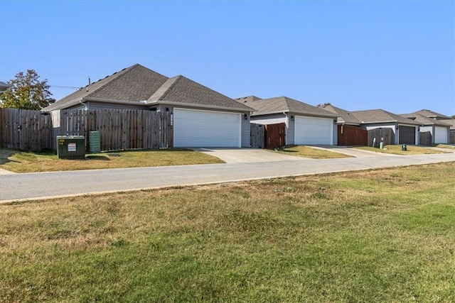 view of front of home with concrete driveway, an attached garage, and central air condition unit