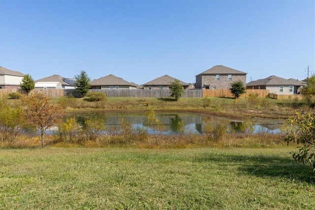 view of yard featuring a water view and fence