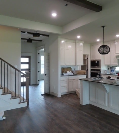 1214 Carrara St, Tontitown, AR 72762 - kitchen featuring appliances with stainless steel finishes, white cabinets, dark wood finished floors, recessed lighting, and dark countertops