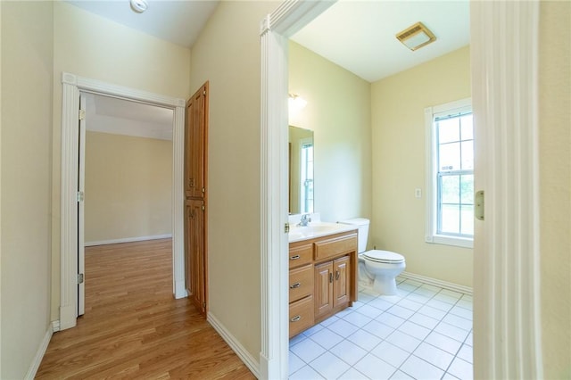 307 E Edmondson Ave, Springdale, AR 72764 - bathroom featuring toilet, vanity, wood finished floors, and baseboards