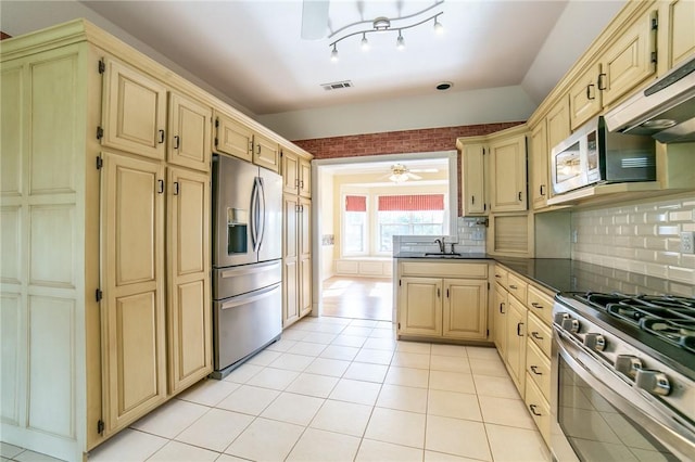 307 E Edmondson Ave, Springdale, AR 72764 - kitchen with stainless steel appliances, a sink, dark countertops, backsplash, and under cabinet range hood