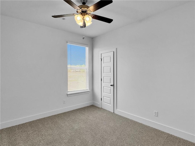 spare room with baseboards, light colored carpet, and a ceiling fan