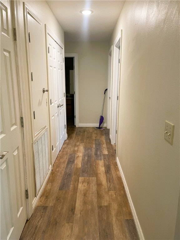 hall featuring wood finished floors and baseboards