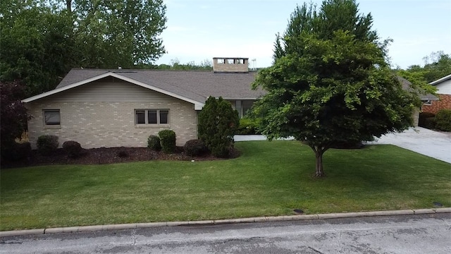 view of front of home featuring a front lawn and brick siding